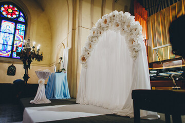 Wedding arch and decoration in interior of Catholic church. High quality photo