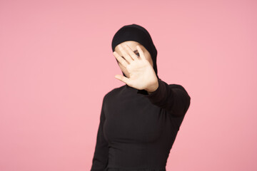 cheerful muslim woman black hijab posing hand gesture pink background