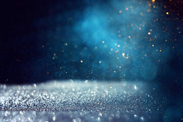 background of abstract glitter lights. gold, blue, silver and black. de focused