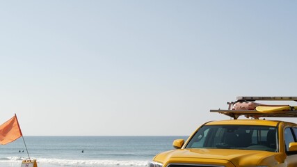 Yellow lifeguard car, Oceanside beach, California USA. Coastline rescue life guard pick up truck,...