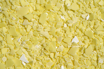 Closeup chemical ingredient on laboratory table (Top View). Sodium sulfide flakes, a yellow...