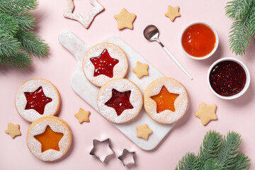 Traditional Linzer cookies with red and yellow jam. Cooking Christmas background