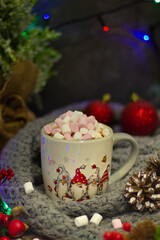 Celebrate winter's joy with this captivating tableau, spotlighting a festive mug, radiant berries, intricate pinecones, and a jovial plush figure keeping a watchful eye.