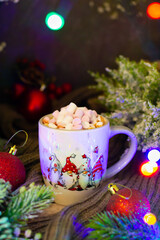 Inviting Christmas scene presenting a drink in an ornate mug, accentuated by the dance of colorful lights, evergreens, and traditional seasonal decorations on rustic wood.