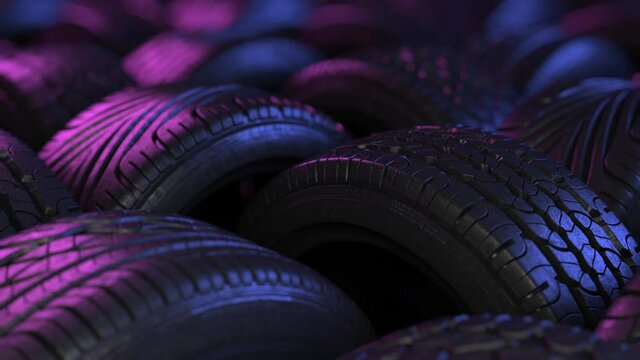 Car tires in elegant studio lighting. The film is looped, arranged in an interesting way in a warehouse or store, the background of the car industry.