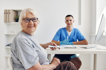 Fototapeta premium old woman at the doctor in the medical office
