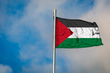 A Flag of Palestinian Authorities flying on a Flagpole against the Sky