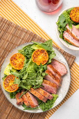 Salad with roasted duck breast and grilled orange tangerines.