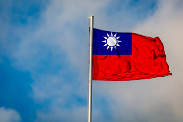 A Flag of Taiwan (Republic of China) flying on a Flagpole against the Sky
