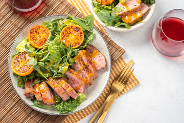 Salad with roasted duck breast and grilled orange tangerines. Natural organic nutrition.