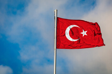A Flag of Turkey flying on a Flagpole against the Sky