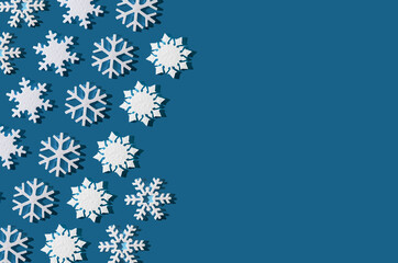 Christmas background. Snowflake pattern. White snowflakes on blue. Snow. Winter mood. Conceptual abstraction. Styrofoam snowflake. New Year's pattern. Copy space.