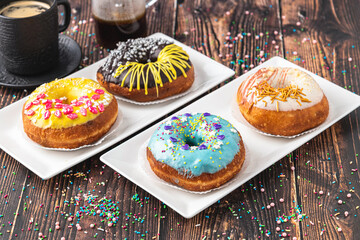 Delicious donuts decorated with different decorations on wooden table