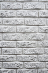 Whie textured rough brick wall vertical photo close up texture background