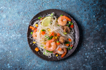 A traditional dish of Asian cuisine. Japanese noodles with shrimps, shiitake mushrooms and vegetables