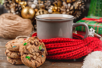 Beautiful Christmas card with a mug of tea and cookies, cozy Christmas decor on a dark background