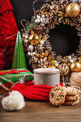 Beautiful Christmas card with a mug of tea and cookies, cozy Christmas decor on a dark background