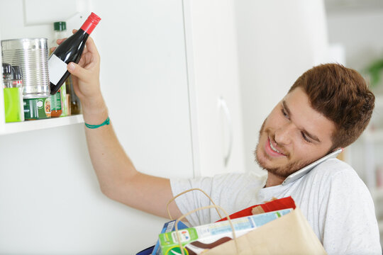 man tyding up after grocery shopping