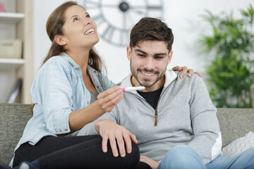 young pregnant couple looking at test