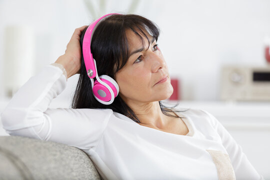 senior woman with headphones listening to music