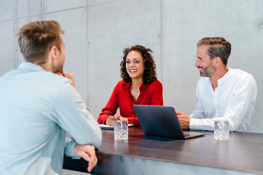Smiling Recruiter Taking Interview Of Candidate In Meeting