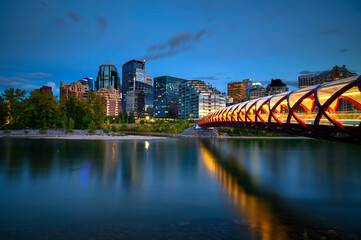 Peace Bridge across the Bow River and Calgary skyline photographed at night