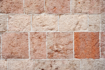 The bright texture of the old tiled wall with ceramic tiles. Traditional European architecture.