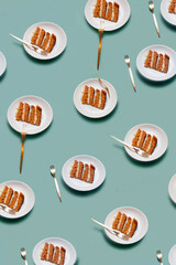 Plate with a piece of carrot cake on light green background pattern minimallistic bright shot