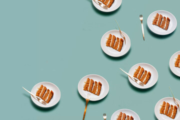 Plate with a piece of carrot cake on light green background pattern minimallistic bright shot