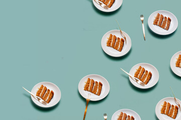 Plate with a piece of carrot cake on light green background pattern minimallistic bright shot