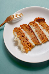 Plate with a piece of carrot cake on light green background pattern minimallistic bright shot