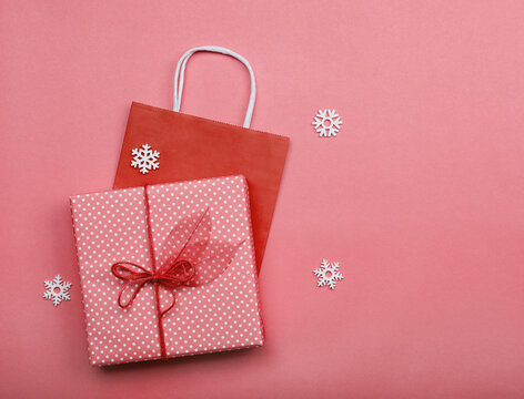 Pink Wrapped Gift Box And Paper Bag On Table