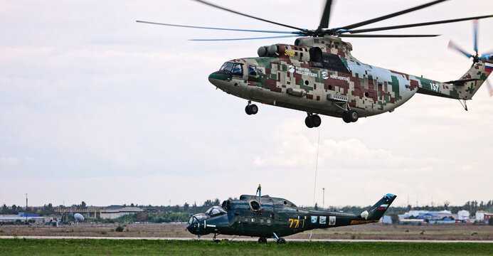 Transport helicopter Mi-26 T2B transports the fuselage of a combat helicopter on the external suspension. Heavy helicopter. On the codification of NATO: Halo. 28.09.2021, Rostov Region, Russia