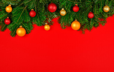 Decorated Christmas tree branches over red