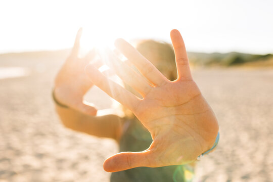 Young woman doing stop gesture with hands at beach