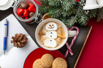 christmas, winter holidays and leisure concept - close up of marshmallow snowman in cup of coffee