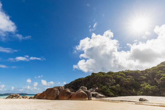Sun shining over boulders lying at Squeaky Beach in Wilsons Promontory National Park