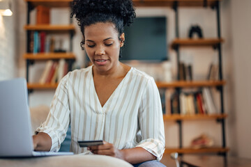 African-american woman, buying with her credit card