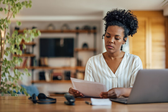 Serious african-american woman, reading a document
