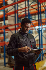 Focused african-american man, easying his job with a tablet