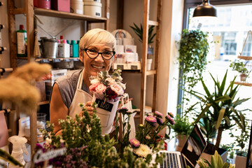Portrait of senior female florist in her flower shop.