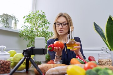 Woman nutritionist recording a video about healthy food, nutrition