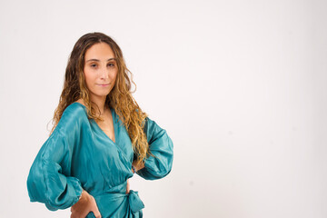 Stylish woman looking at camera while posing on an isolated background.