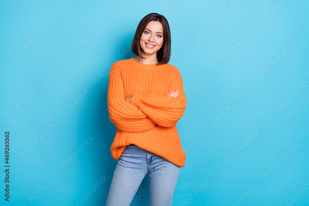 Sticker Portrait of attractive cheerful content girl folded arms posing wearing cosy clothes isolated over bright blue color background