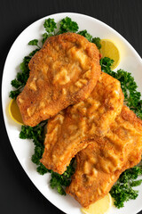 Homemade Fried Pork Chops on a White Plate, overhead view. Flat lay, top view, from above.