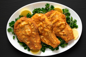 Homemade Fried Pork Chops on a White Plate, top view. Flat lay, overhead, from above.