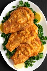 Homemade Fried Pork Chops on a White Plate, top view. Flat lay, overhead, from above.