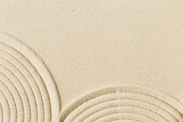 Fototapeta na wymiar Lines drawing on sand, beautiful sandy texture. Spa background, concept for meditation and relaxation
