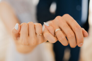 Newlyweds hold hands, hold hands together with little fingers, holding hands together in the...