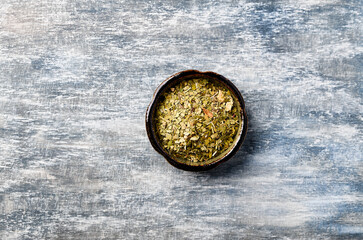 Fototapeta na wymiar Dry yerba mate leaves on wooden background. Top view. Close up. Copy space. 